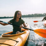 Couple kayaking together. Beautiful young couple kayaking on lak